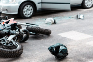 A motorcycle and a car are involved in a crash.